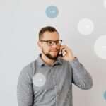 Professional man talking on smartphone with overlay arrow graphics, symbolizing communication.